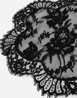 Asymmetrical lace top with flower detail on neck