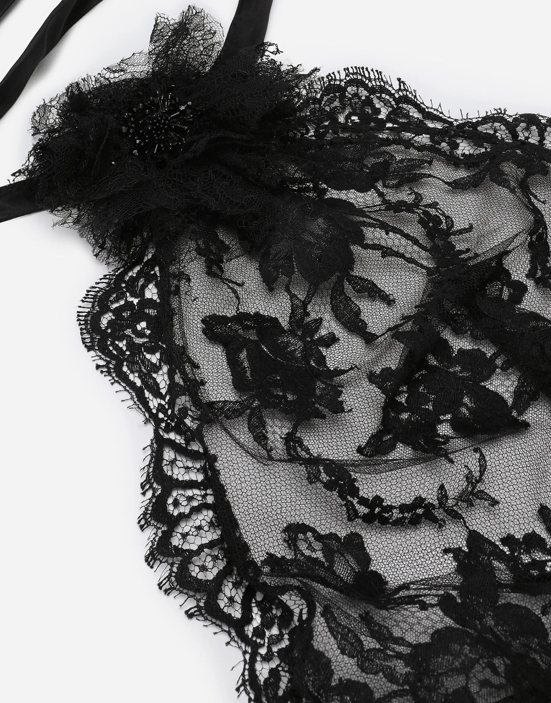 Asymmetrical lace top with flower detail on neck