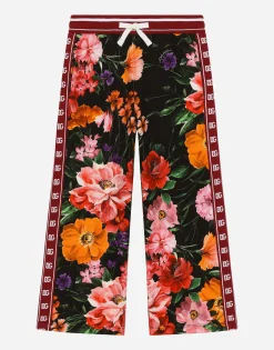 Jersey jogging pants with floral print over a black background