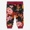 Jersey jogging pants with floral print over a black background