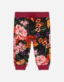 Jersey jogging pants with floral print over a black background