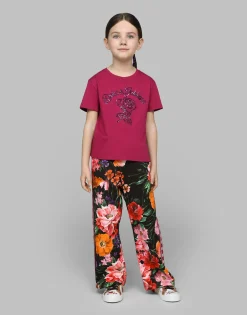 Jersey jogging pants with floral print over a black background