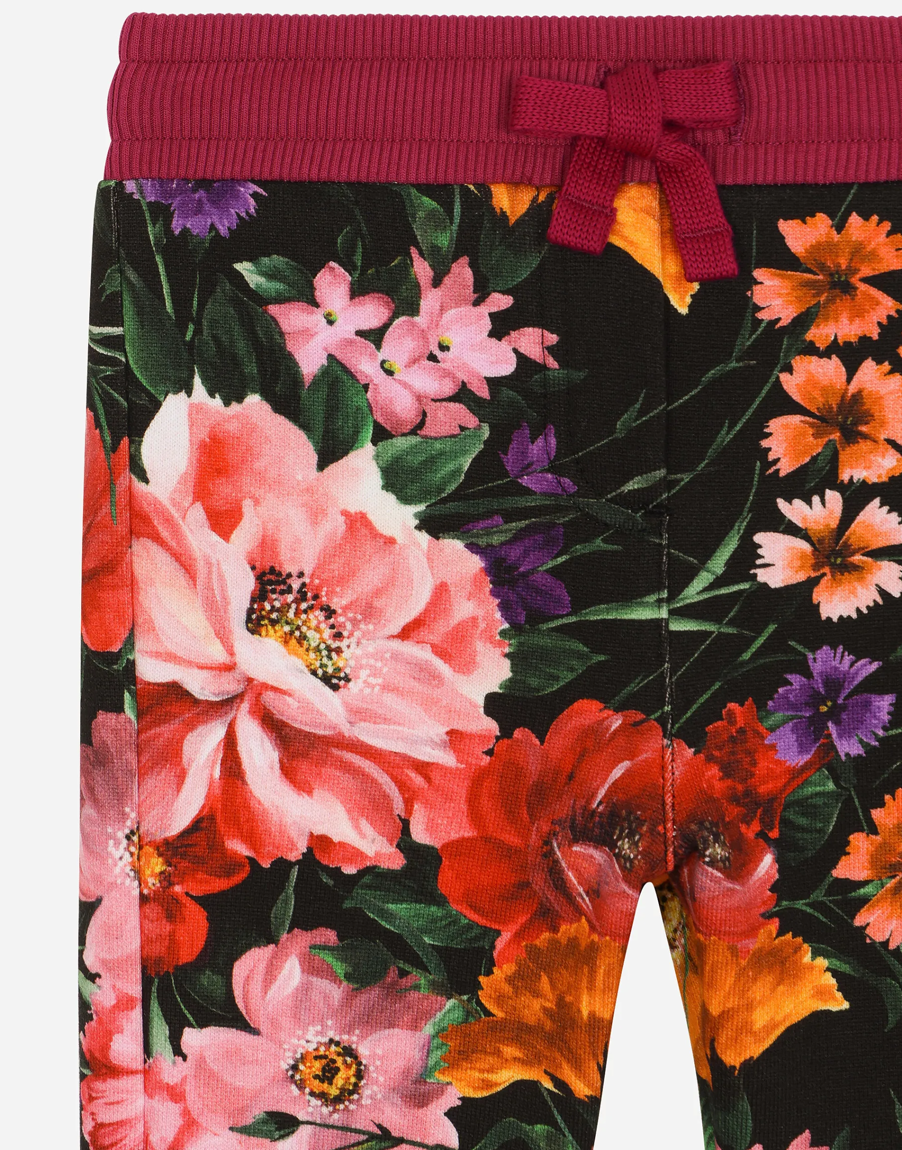Jersey jogging pants with floral print over a black background