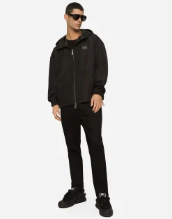 Nylon jacket with hood and branded tag