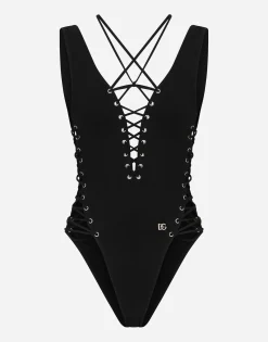 One-piece swimsuit with plunging neckline and lacing and eyelets