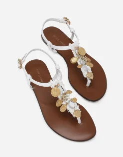 Raffia thong sandals with embroidered votive medallions